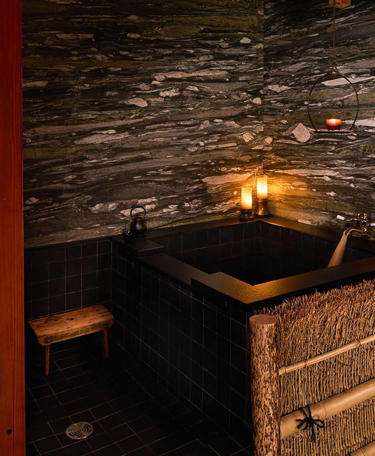 A deep, candlelit soaking tub at Shibui Spa, The Greenwich Hotel
